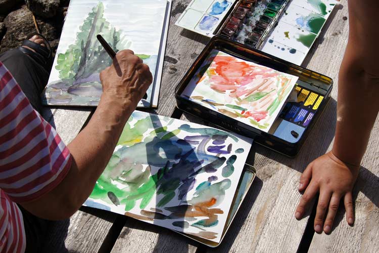 Starting the watercolor by lightly sketching the main shapes. The Puukonsaari art workshop.